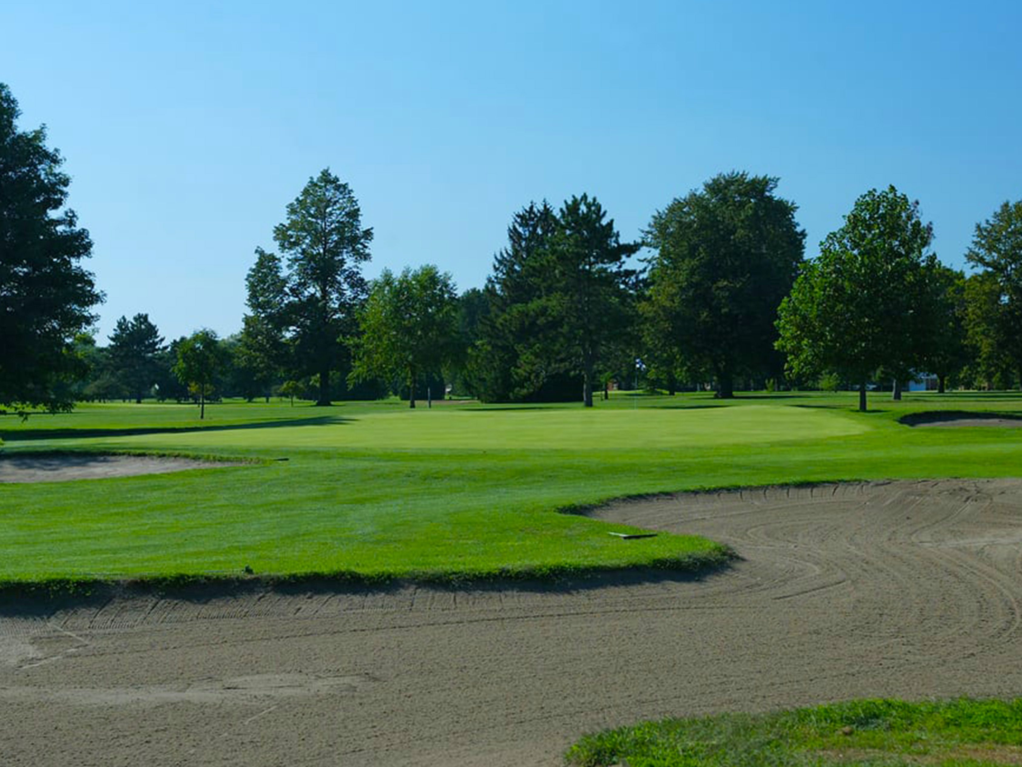 Landscape view of Madison Golf Course with fairway and green