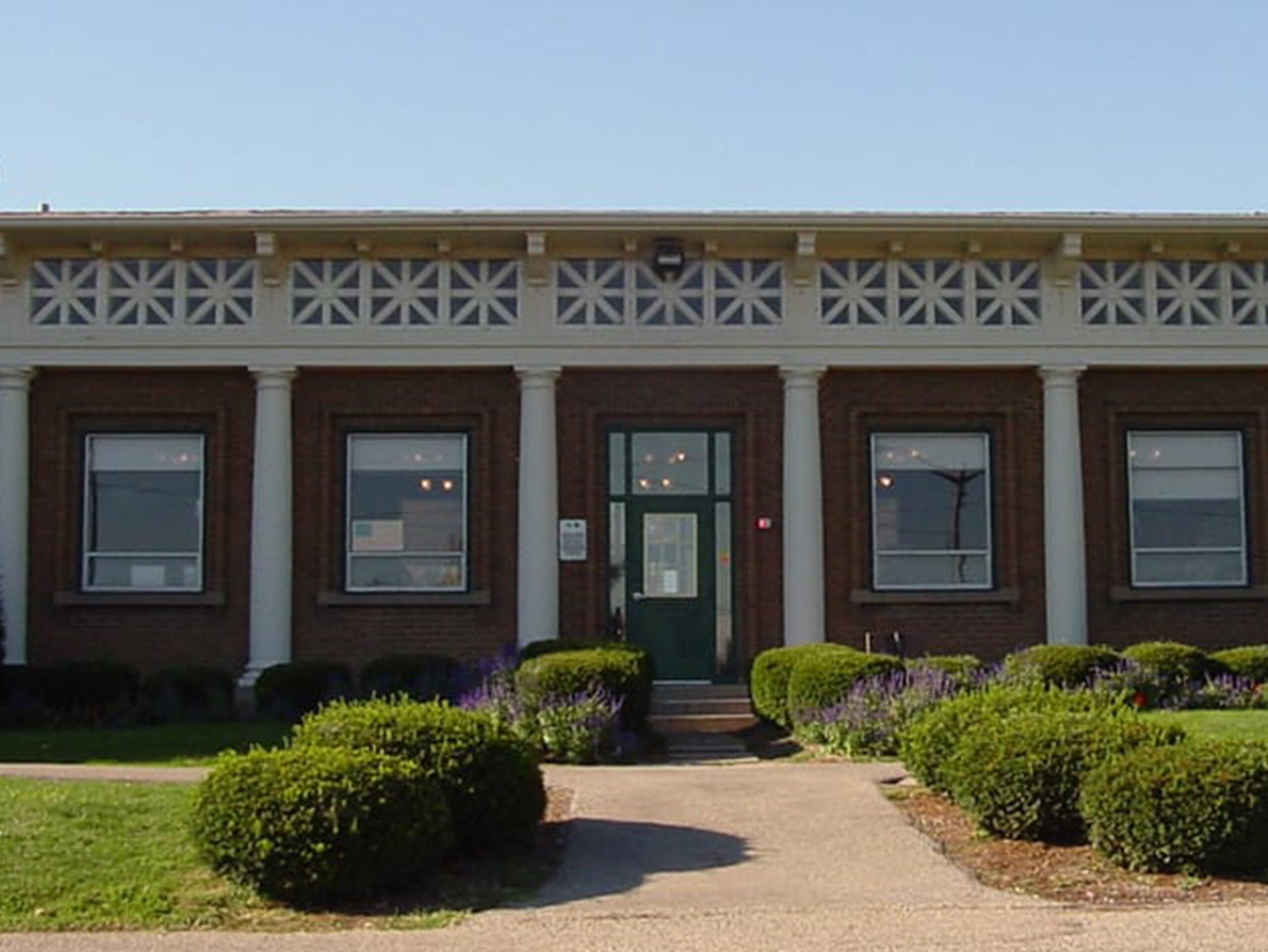 Brick building with green door and windows