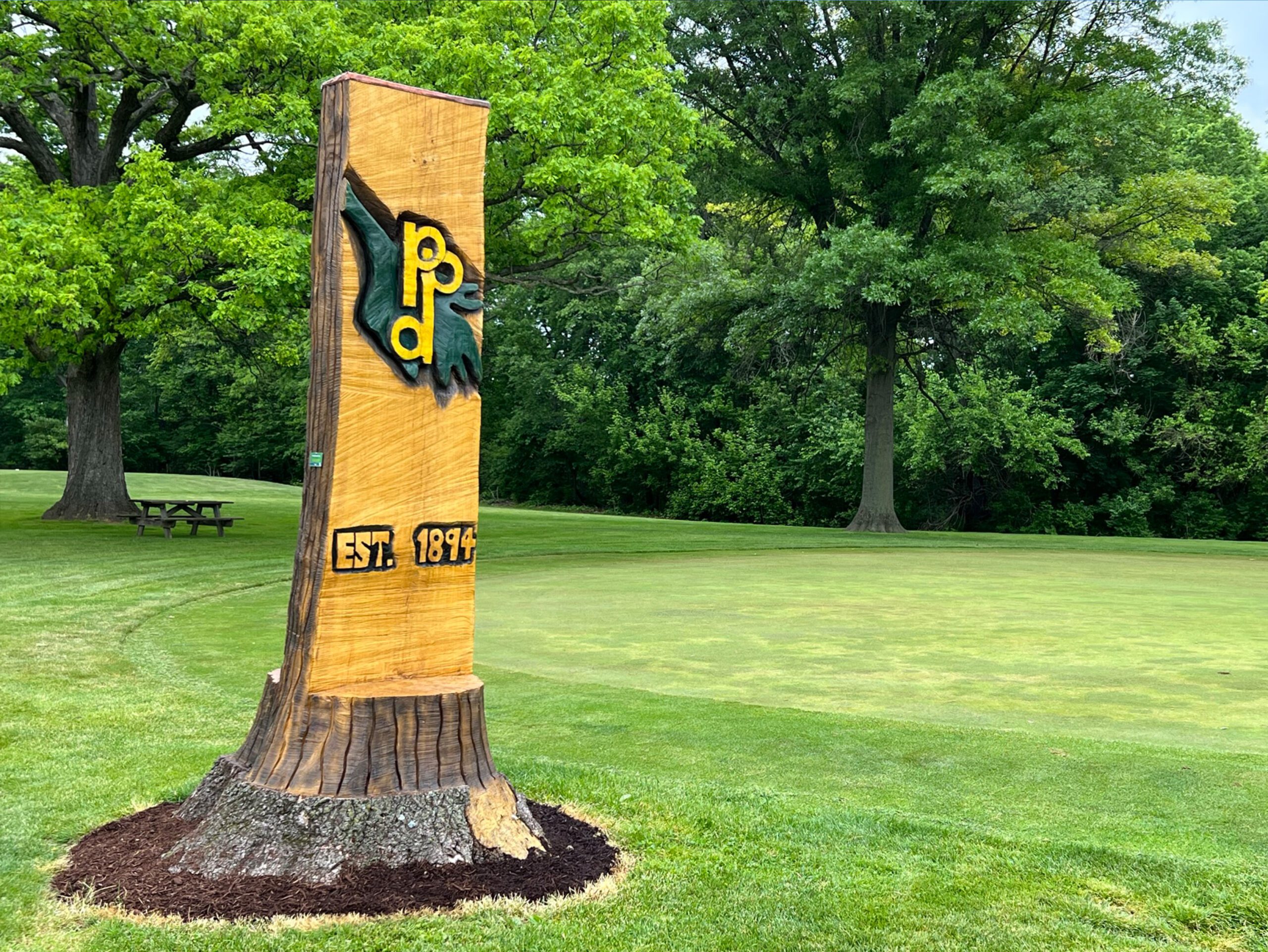 Wooden sign at golf course entrance